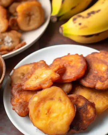 Close-up of golden crispy banana fritters on a plate