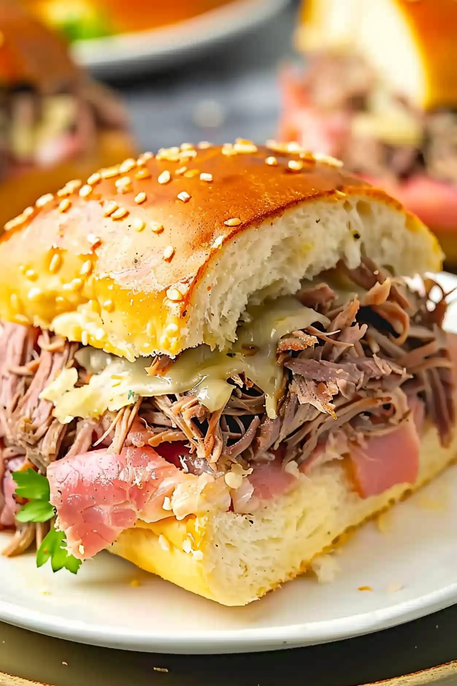 Perfectly baked roast beef sliders with melted cheese ready to serve.